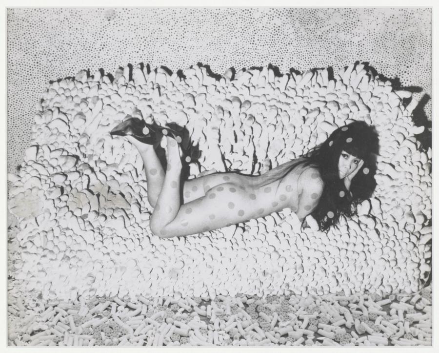 Photograph of collage (circa 1966) by Yayoi Kusama, with the artist reclining on 'Accumulation No. 2'