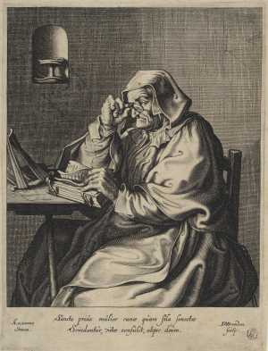 oude-vrouw-met-bril-zittend-aan-een-tafel
