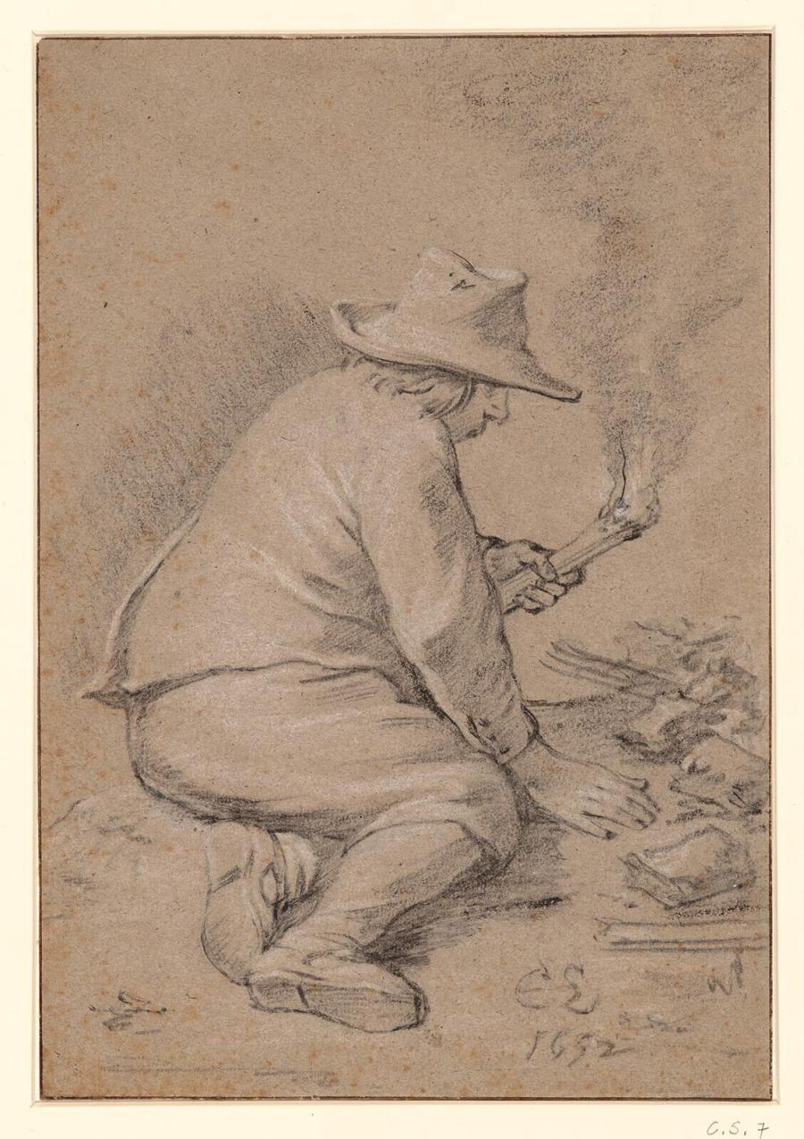 A Man Sits on the Ground with a Torch in His Hand