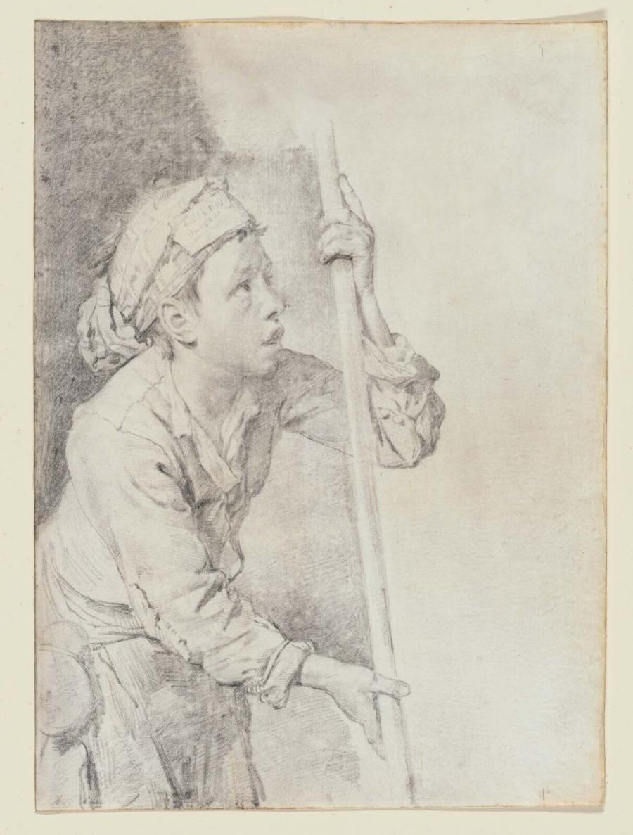 Boy holding a stick looking upward